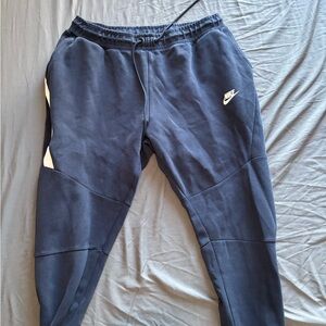 Navy blue Nike tech pants